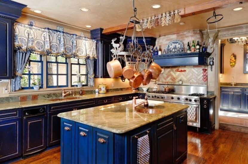 The spacious kitchen has royal blue cabinets.