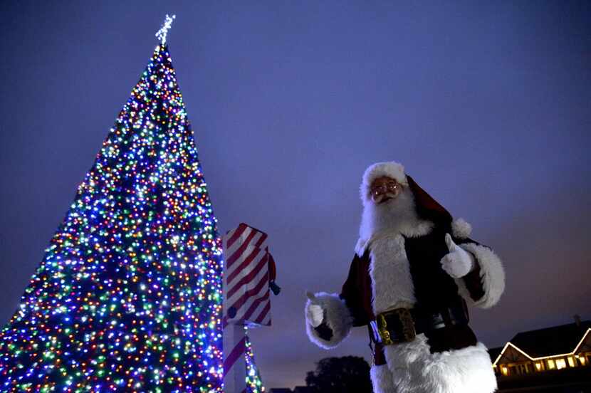 In this file photo, Ken McClure, dressed as Santa, gives a thumbs up after pulling a lever...