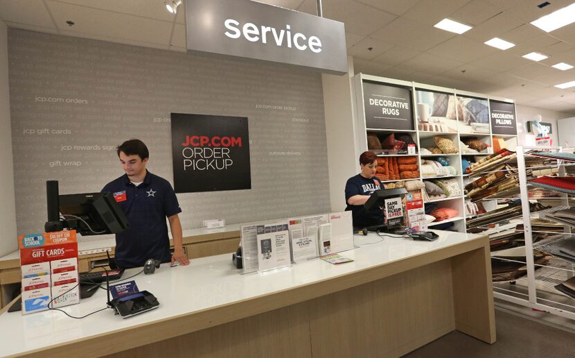 Rhett Biehahn (left) and Tami Doss work Penney's pickup counter for online purchases at the...