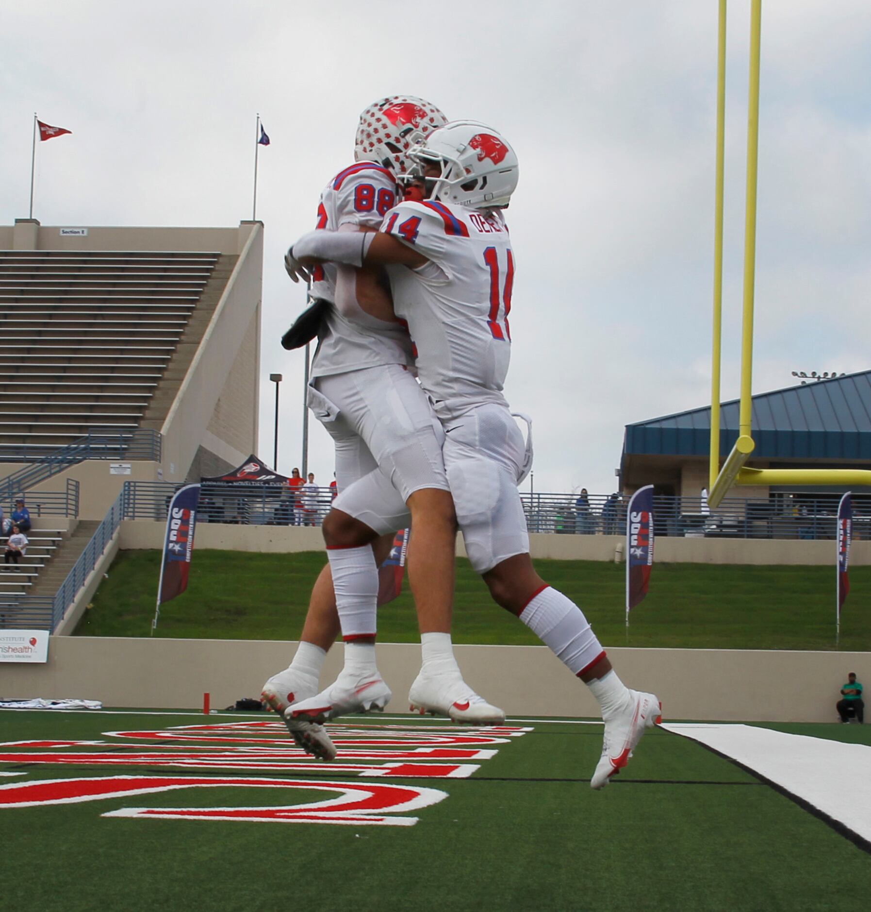 Parish Episcopal defensive back Daniel Demery (14), right, leaps in celebration with...
