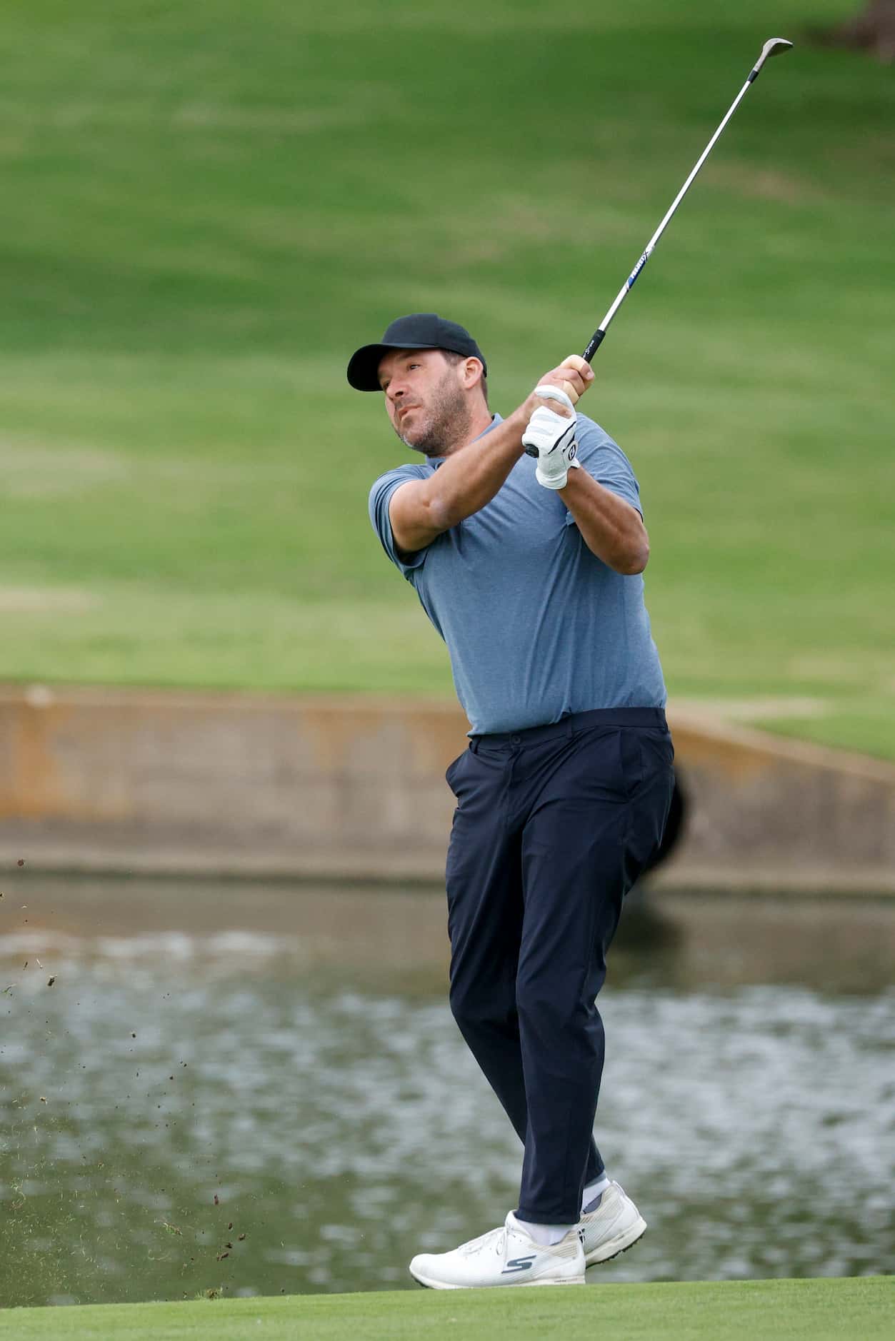 Former Dallas Cowboys quarterback Tony Romo plays a shot from the 18th fairway during the...
