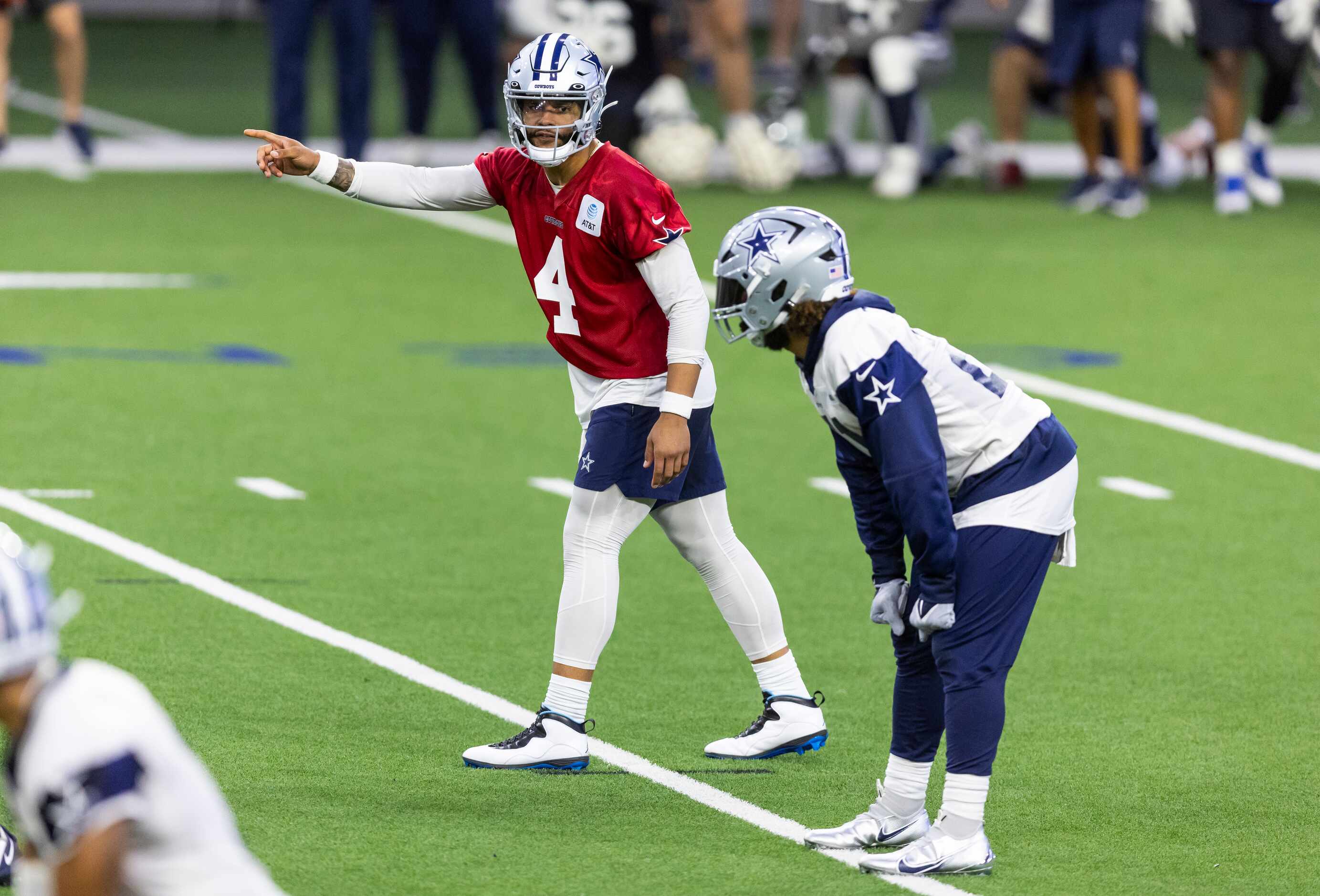 Dallas Cowboys quarterback Dak Prescott (4) signals to running back Ezekiel Elliott during a...