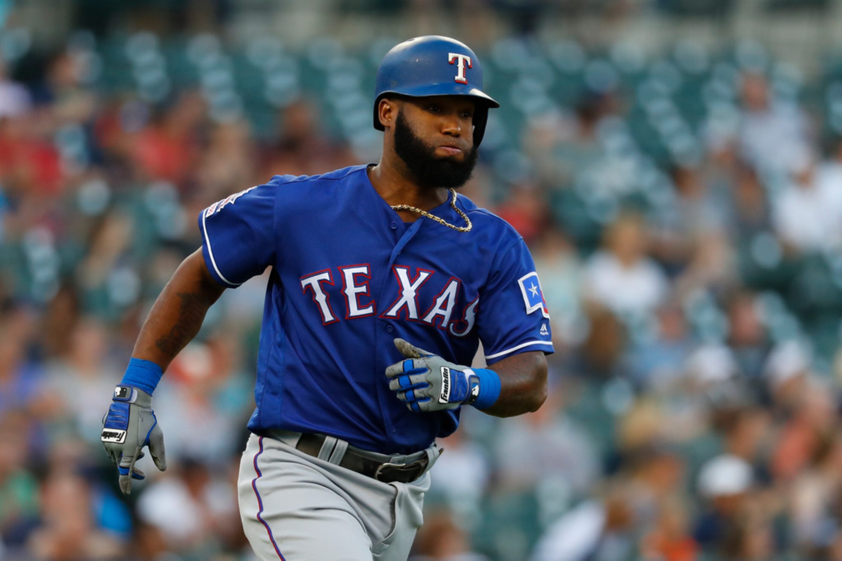 Texas Rangers' Danny Santana rounds first base after hitting a solo home run in the fifth...