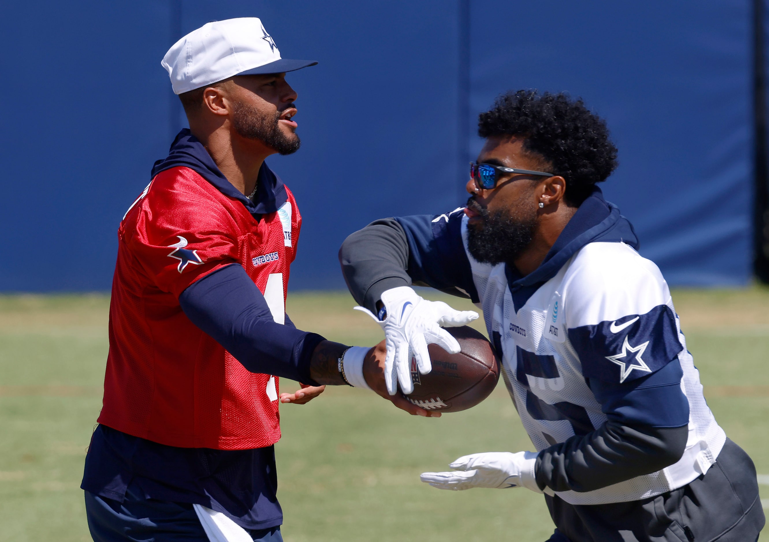 Dallas Cowboys quarterback Dak Prescott (4) hands the ball off to running back Ezekiel...