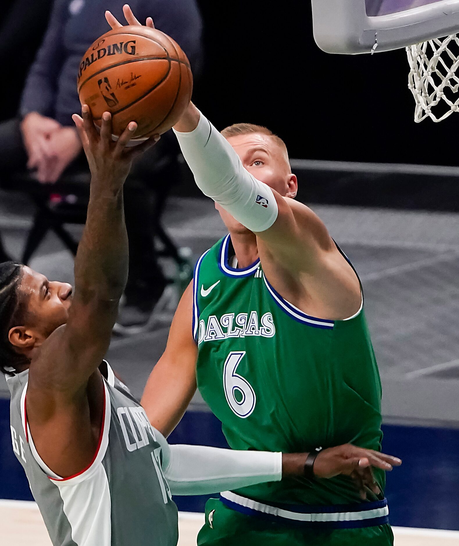 Dallas Mavericks center Kristaps Porzingis (6) defends against LA Clippers guard Paul George...