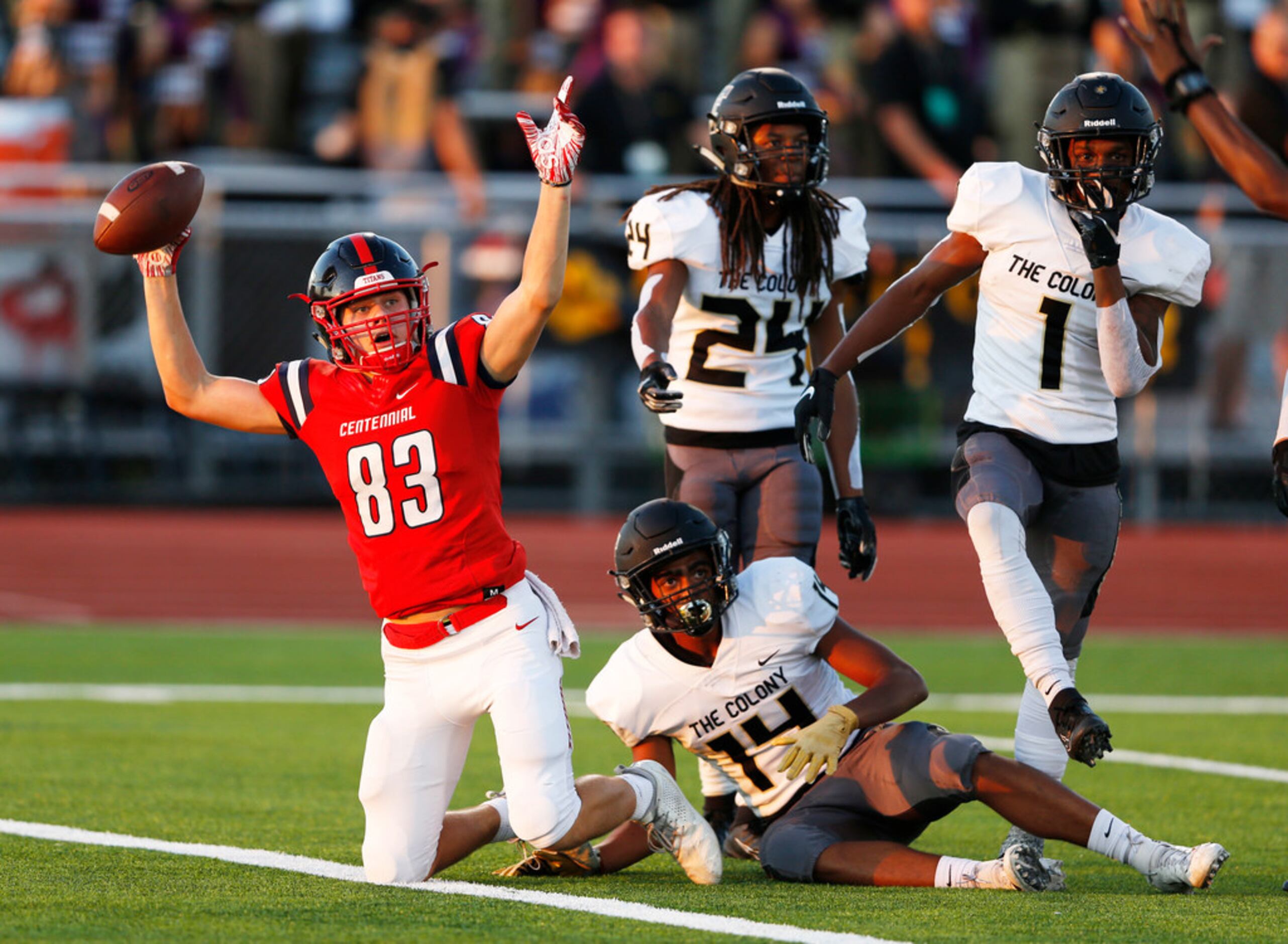 Centennial's Jacob McCoy (83) signals a touchdown after scoring a touchdown as The Colony's...