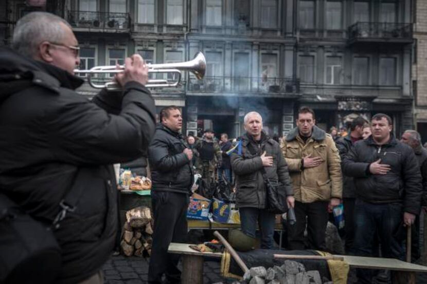 
A group sang the national anthem at protest barricades in Kiev, Ukraine, on Sunday....