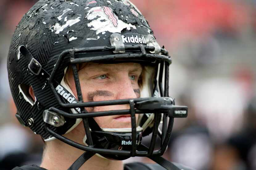 Colleyville Heritage senior defensive lineman Michael Prescott's helmet shows the scars of a...