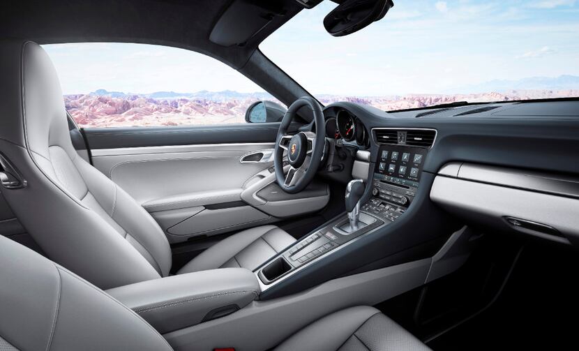The three-spoke steering wheel has a small dial that can be turned to normal, sport,...