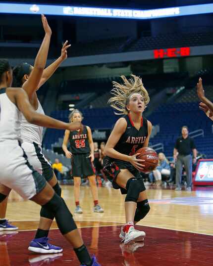 Argyle's Rhyle Mckinney drives to basket against Houston Wheatley in a UIL girls basketball...