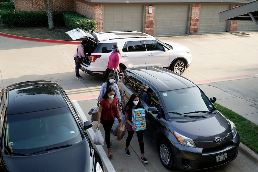 Volunteers deliver sandwiches and other supplies to the home of Eric and Shakti Biskamp in...