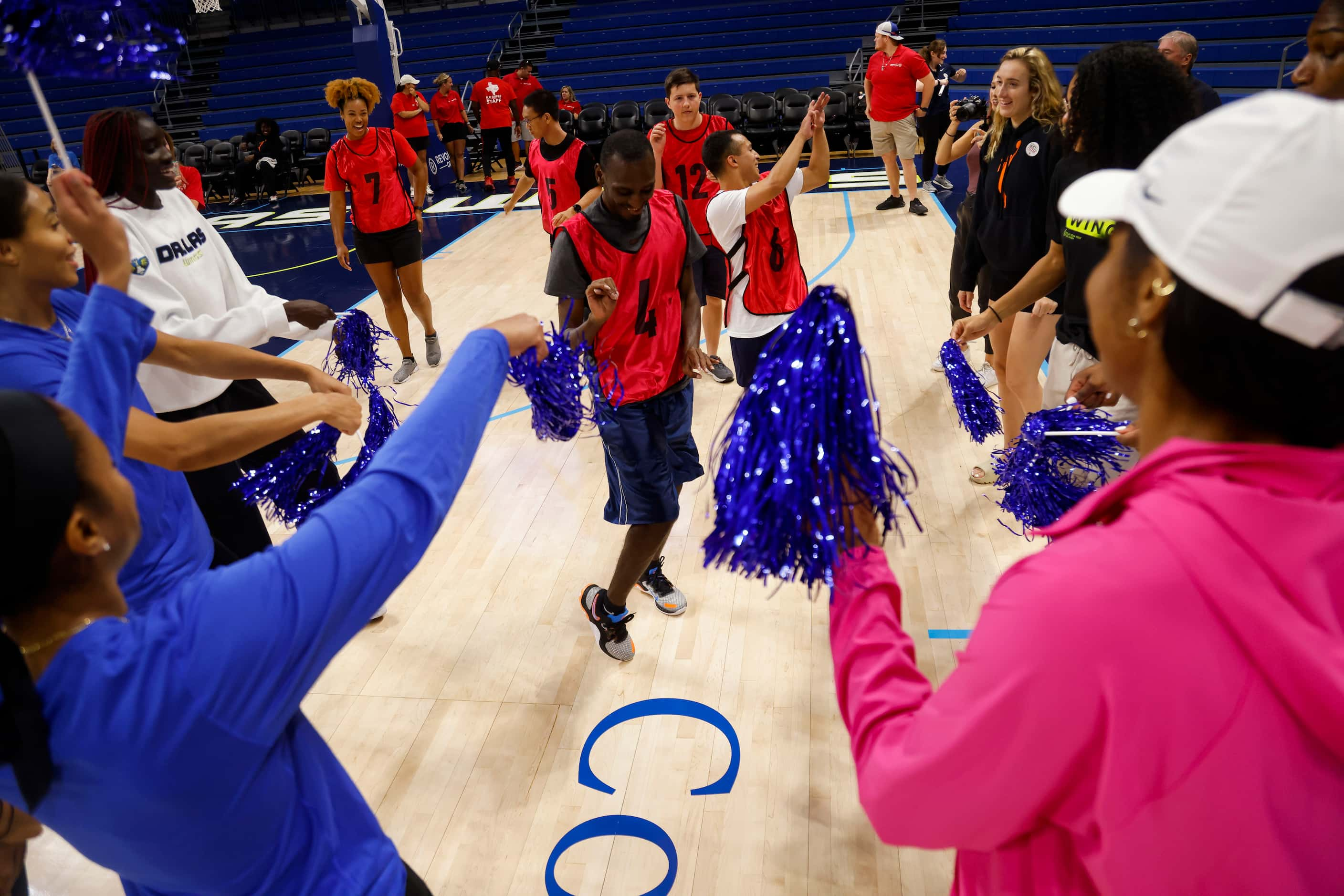 Dallas Wings players celebrate as Team Marina’s Brock Krandolph (4) and Jared Futnez (6)...