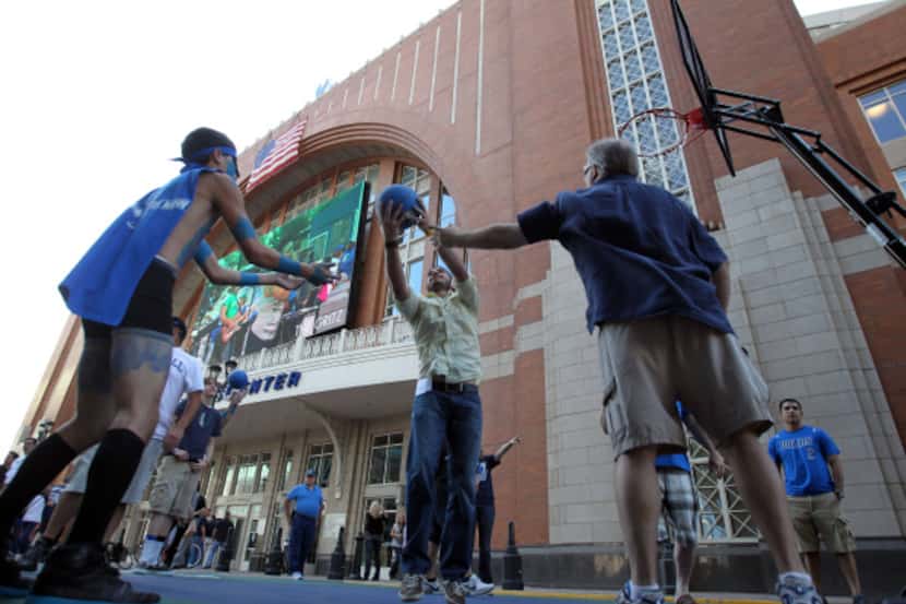 Dallas Mavericks fans shot some hoops on a makeshift court Tuesday night before Game 1 of...