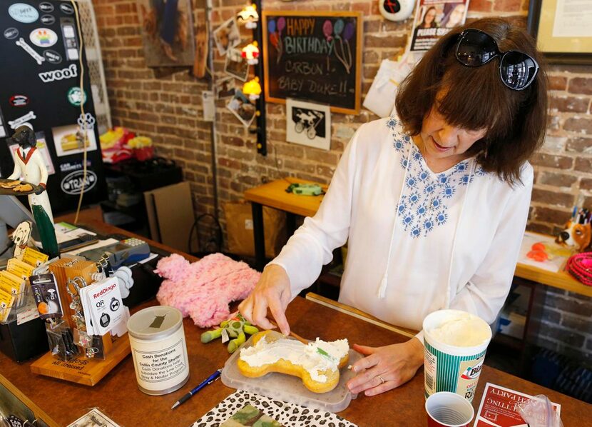 
Stephanie Farrar, icing a Pupcake for a customer, began her business when she made her own...