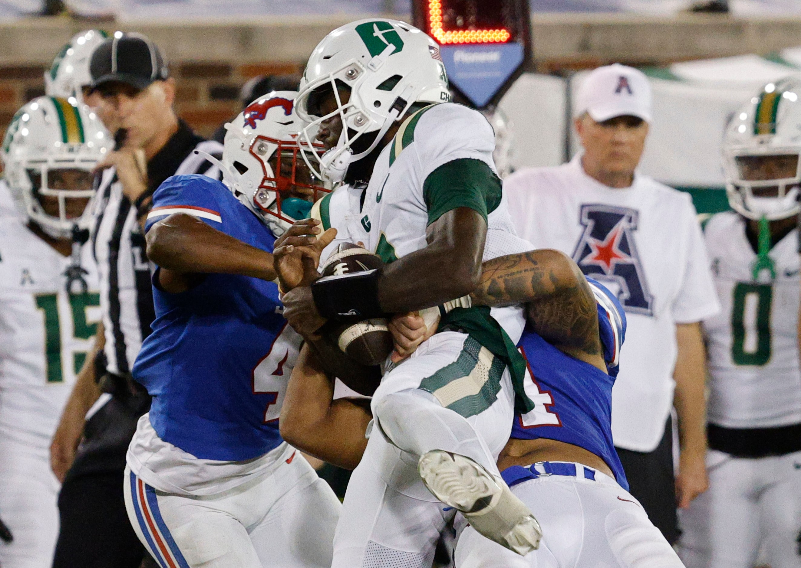 Charlotte 49ers quarterback Jalon Jones (4) is tackled by SMU cornerback Jahari Rogers (4)...