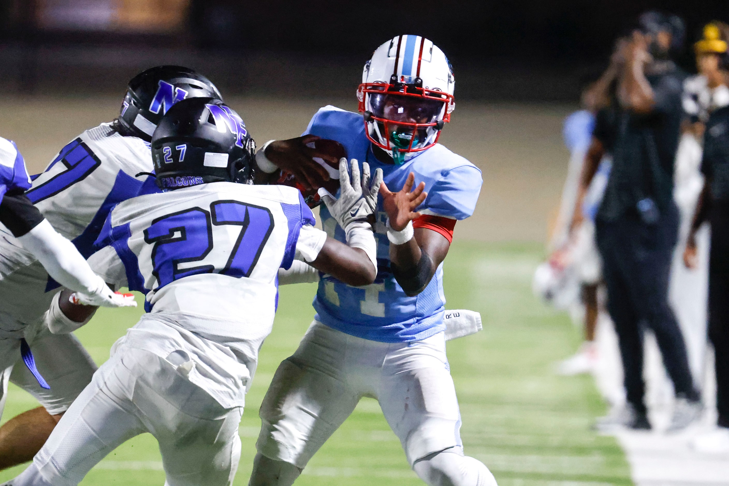 Skyline High’s QB Donte Ware (right) is tackled by North Forney High’s Gianni Edwards (27)...