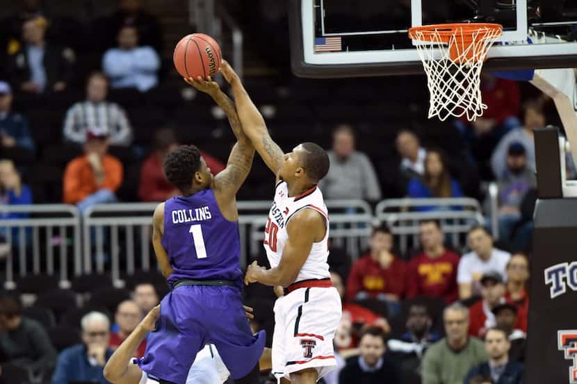 TCU Horned Frogs guard Chauncey Collins (1) scores over Texas Tech Red Raiders guard...