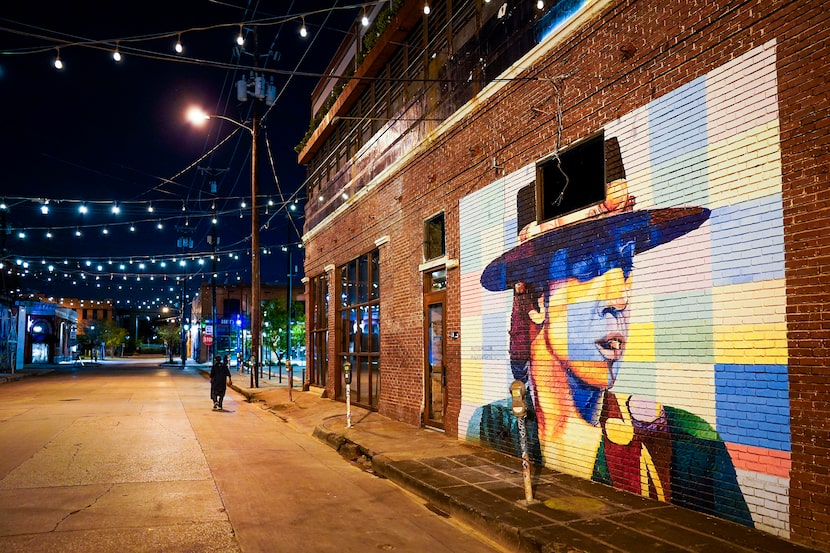 Crowdus Street in Deep Ellum sits empty except for one pedestrian at around 9:00 p.m. on ...