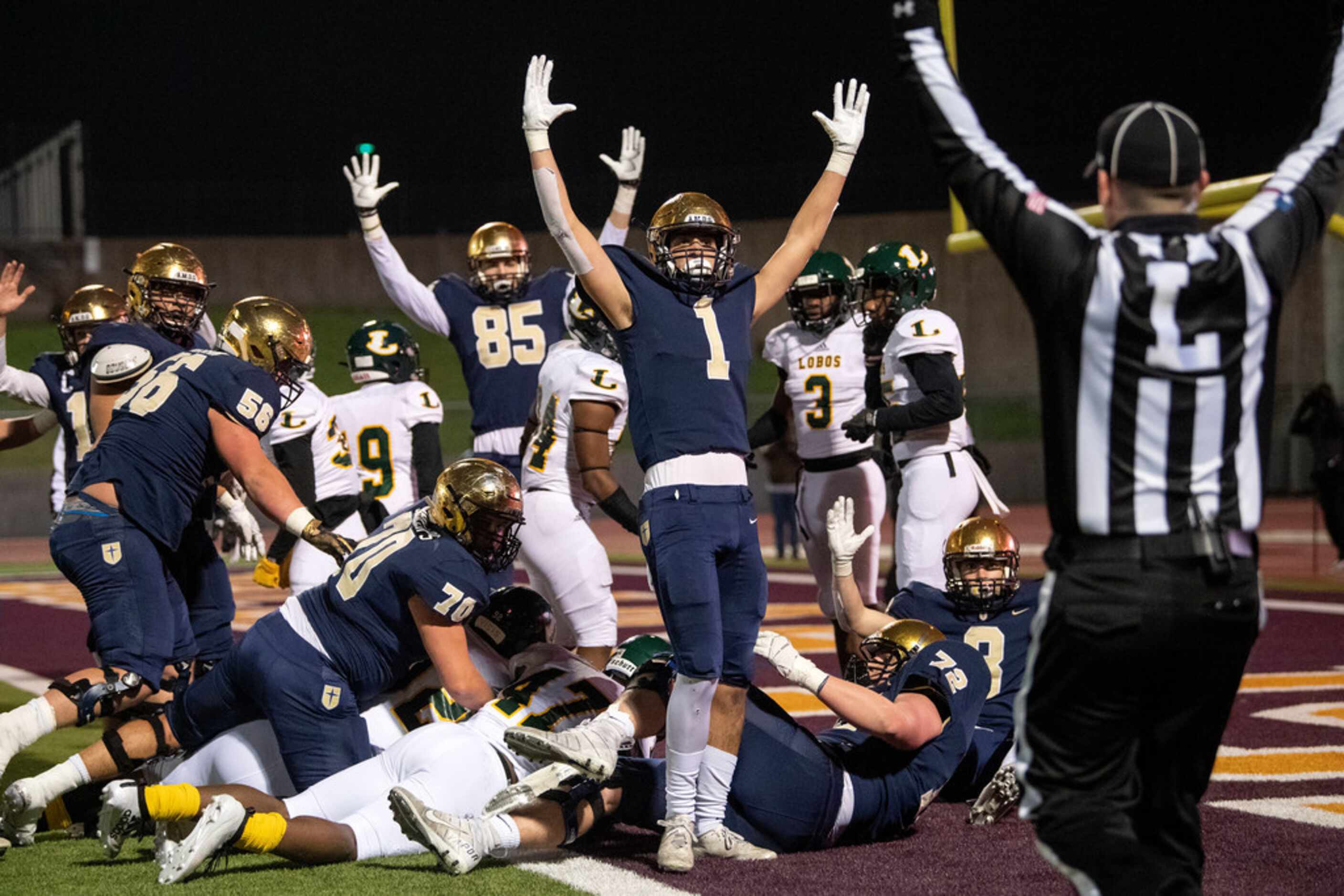 Jesuit senior wide receiver Christian Allocco (1) and his teammates signal for a touchdown...
