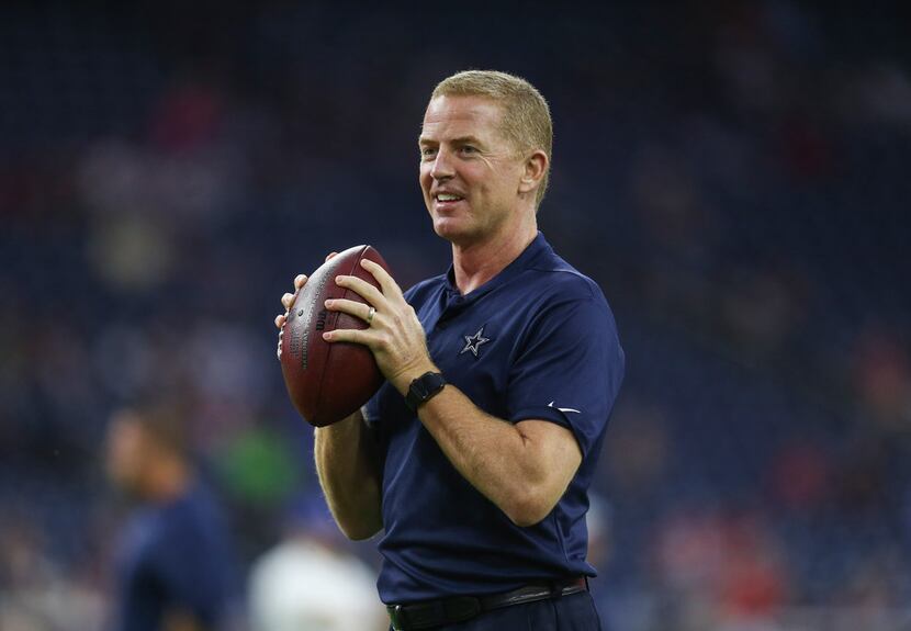 Dallas Cowboys head coach Jason Garrett tosses the ball around during warm ups prior to a...