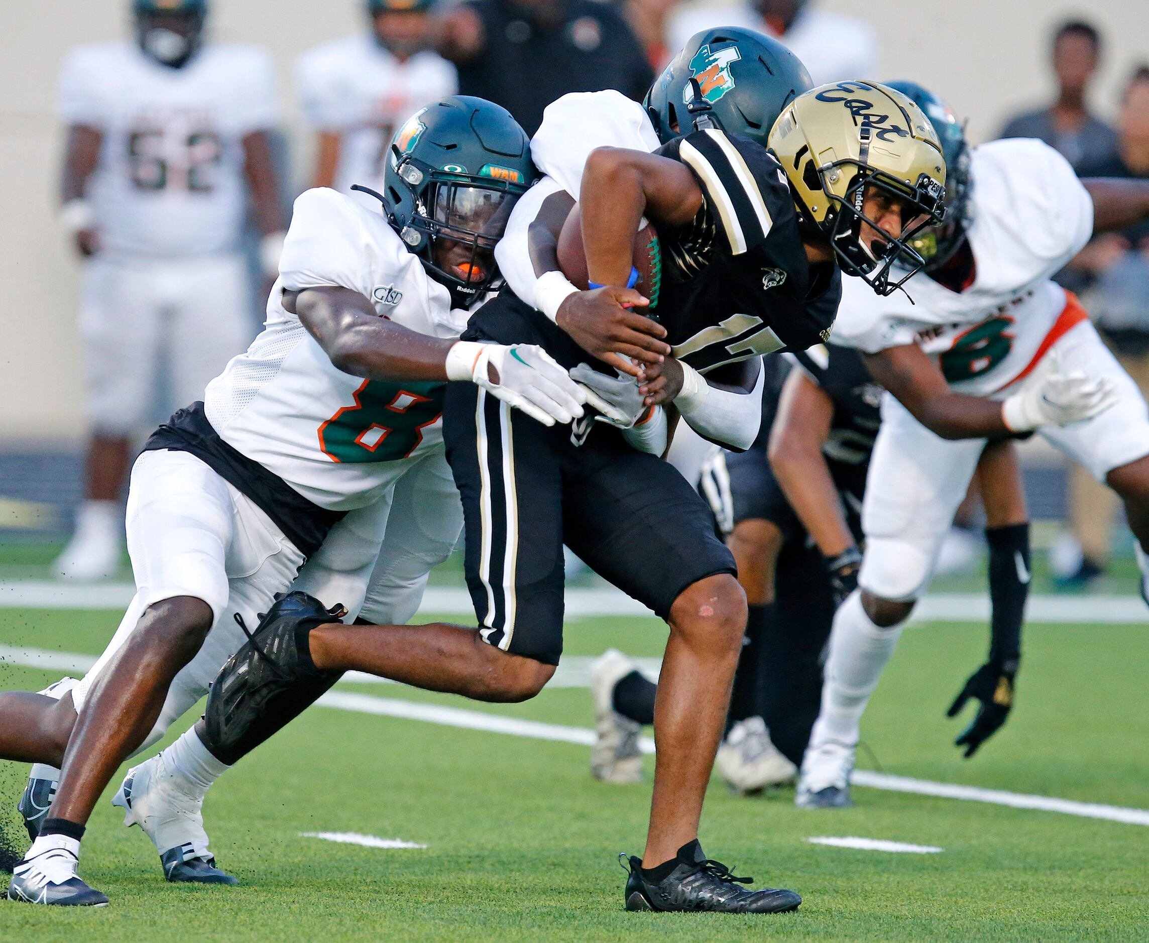 Plano East Senior High School wide receiver Joshua Palma (17) is tackled by Naaman Forrest...