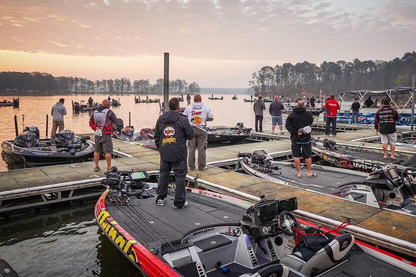 Bass anglers stand at attention for the national anthem at the start of the FLW Pro Circuit...