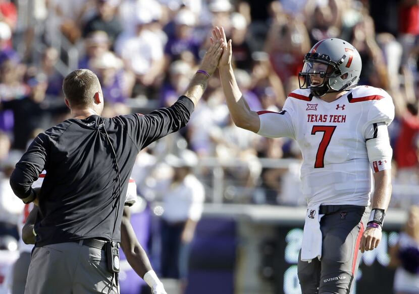 Texas Tech head coach Kliff Kingsbury, left, celebrates with quarterback Davis Webb (7)...
