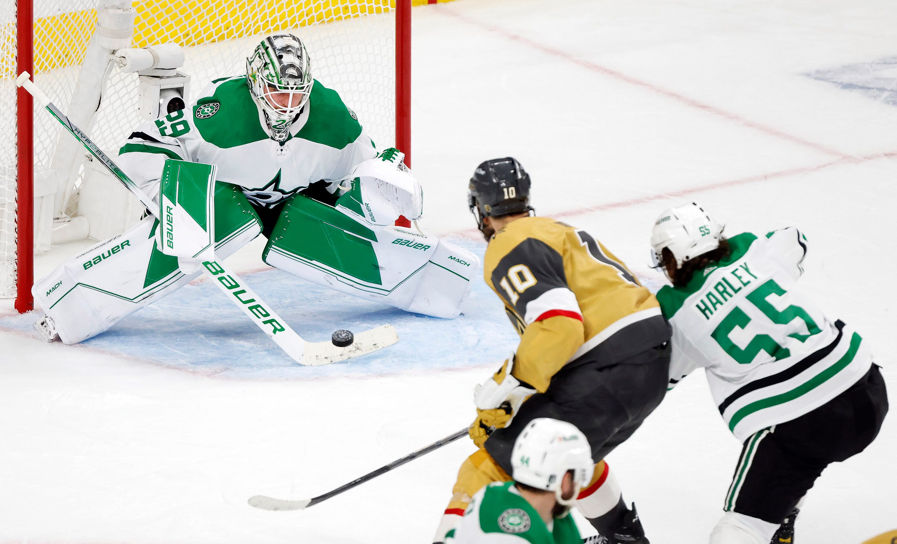 Dallas Stars goaltender Jake Oettinger (29) stops a shot by Vegas Golden Knights center...