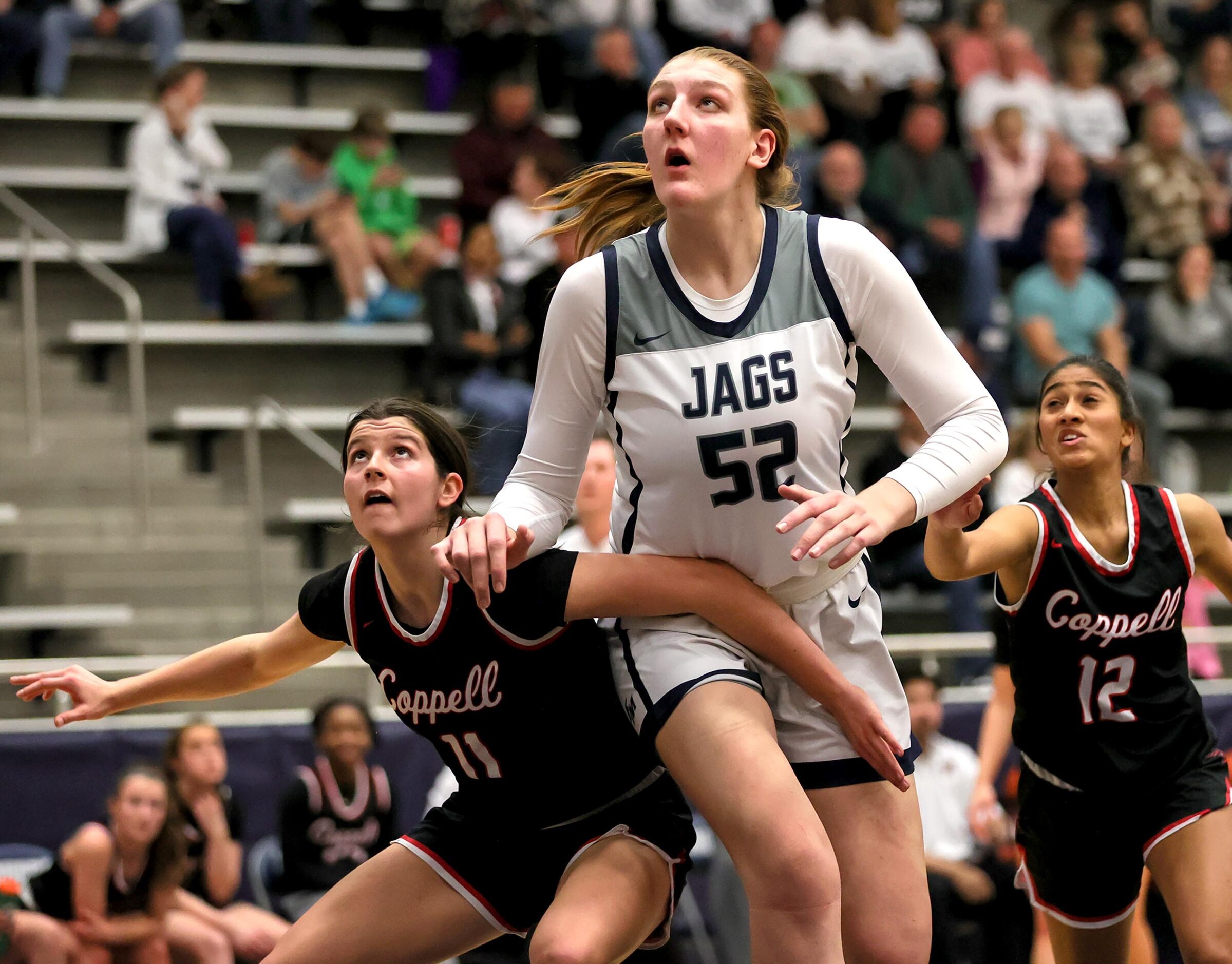 Flower Mound center Abbie Boutilier (52) looks to rebound against Coppell during the first...