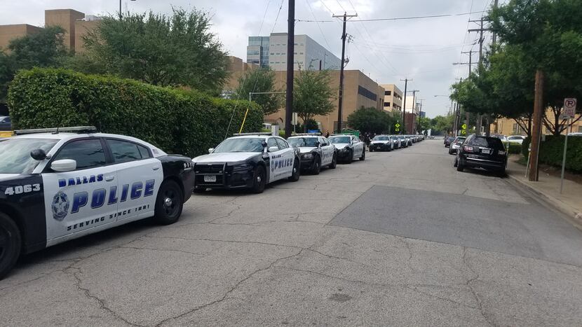 Squad cars waited outside Baylor University Medical Center's rehab facility to escort...
