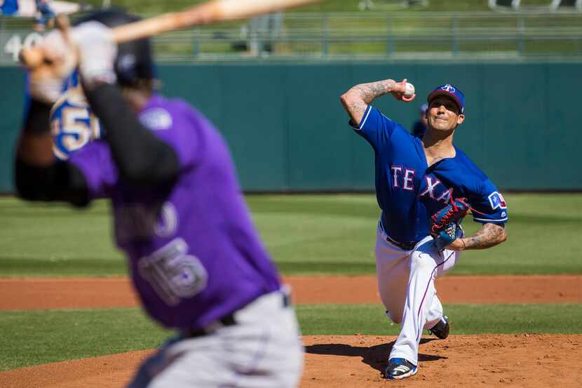Texas Rangers pitcher Matt Bush pitches during the first inning of a spring training...