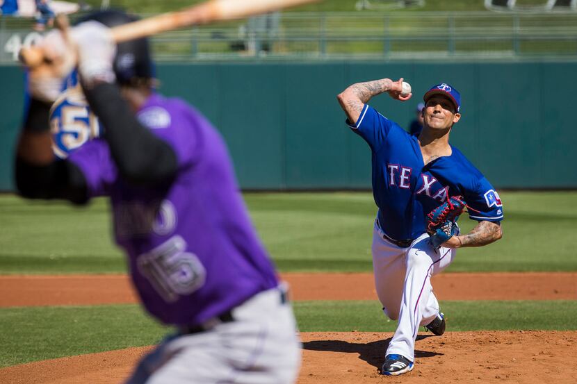 Texas Rangers pitcher Matt Bush pitches during the first inning of a spring training...