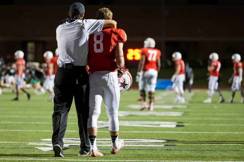 Coppell wide receiver Josh Fink (8) is consoled by a coach following an overtime loss to...