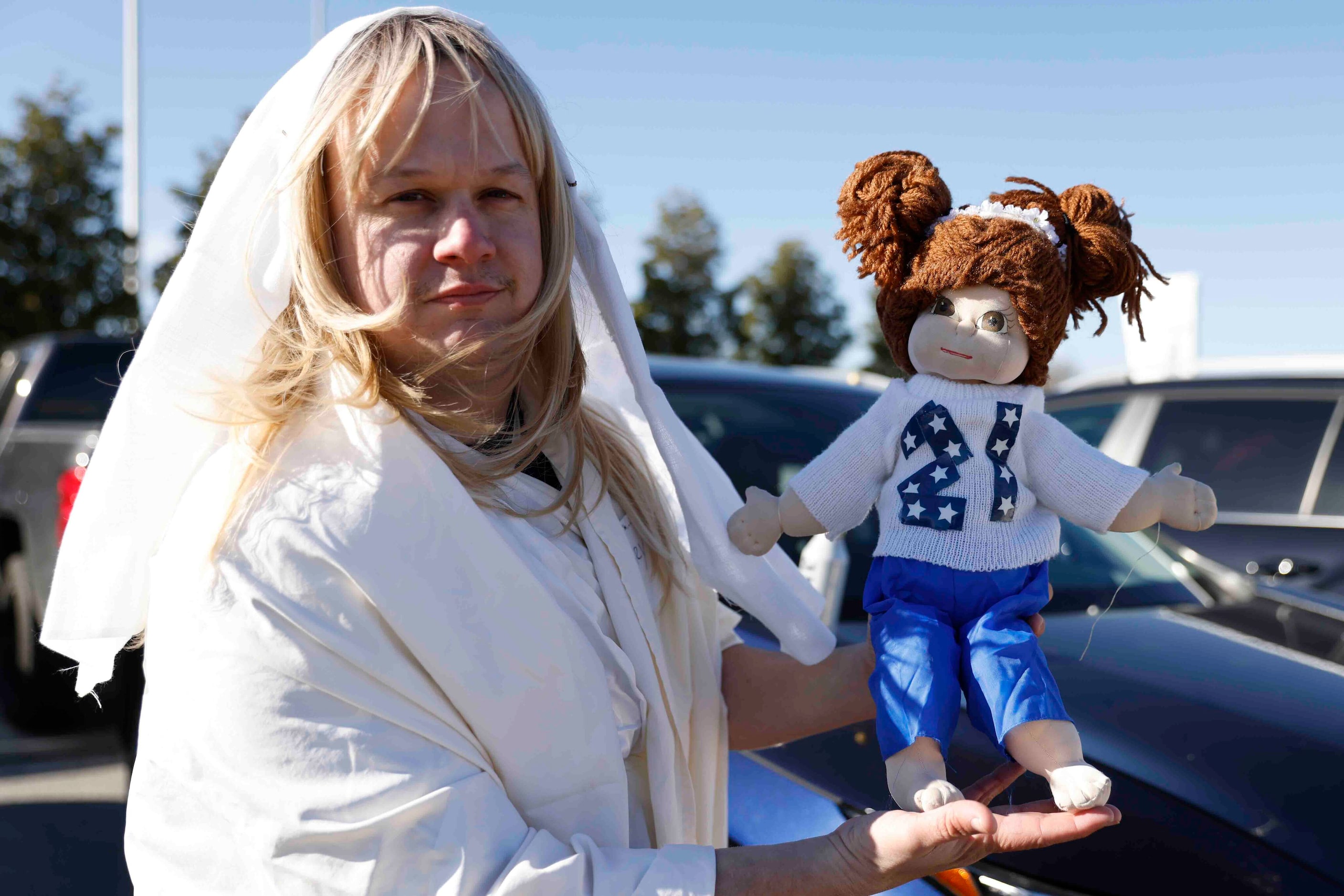 Jacob Wilson holds a doll lookalike Ezekiel Elliott as he tails gaits ahead of a NFL game...