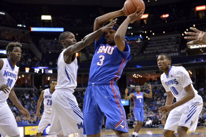 SMU guard Sterling Brown (3) struggles for control of the ball against Memphis forward...