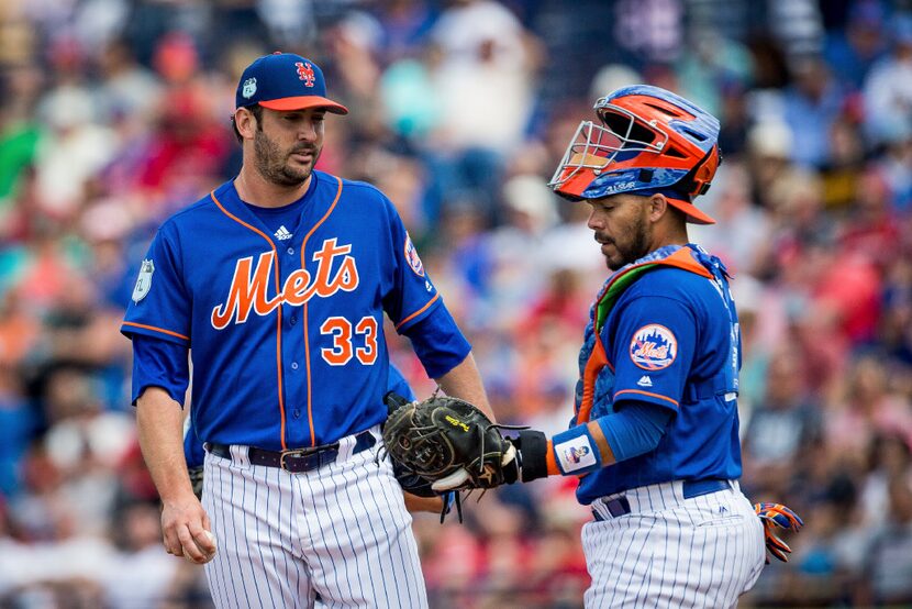 Matt Harvey (33), pitcher for the New York Mets, speaks to Rene Rivera as Harvey is taken...