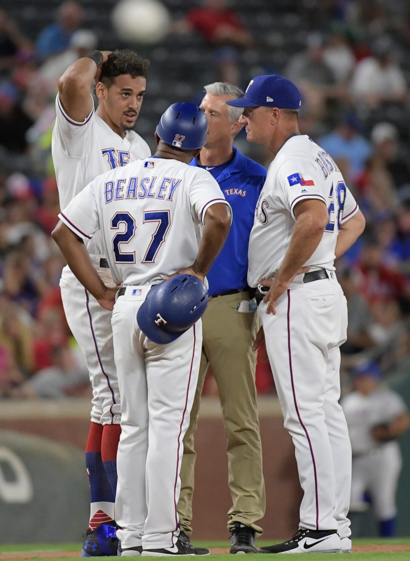 Texas Rangers first baseman Ronald Guzman (67) is injured on a pick off attempt at third...