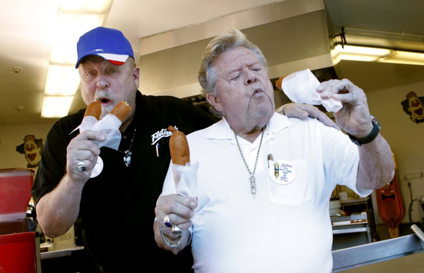 Fletcher brothers, Bill (left) and Skip (right) taste test their first corny dogs on the...