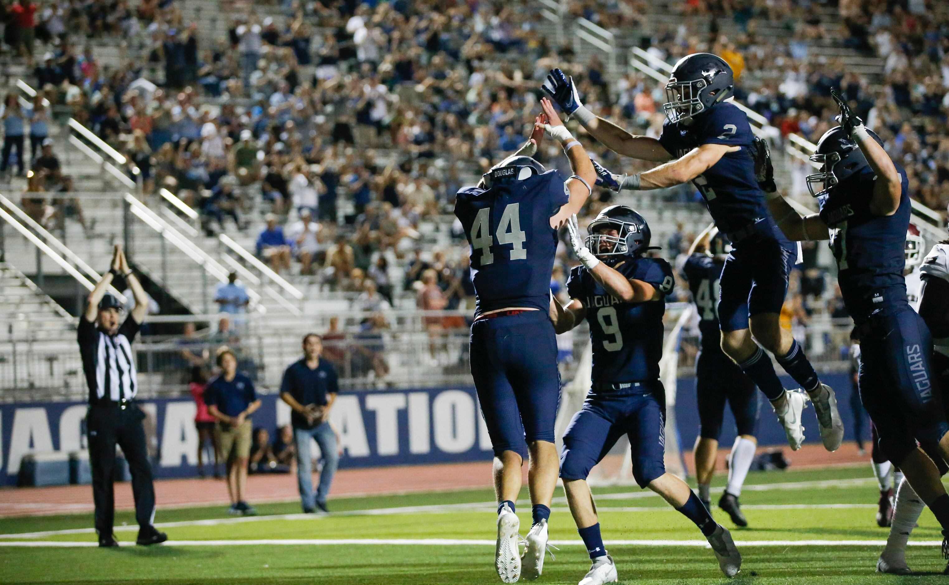 Flower Mound senior linebacker Ryan Brubaker (44) is congratulated by teammates after...