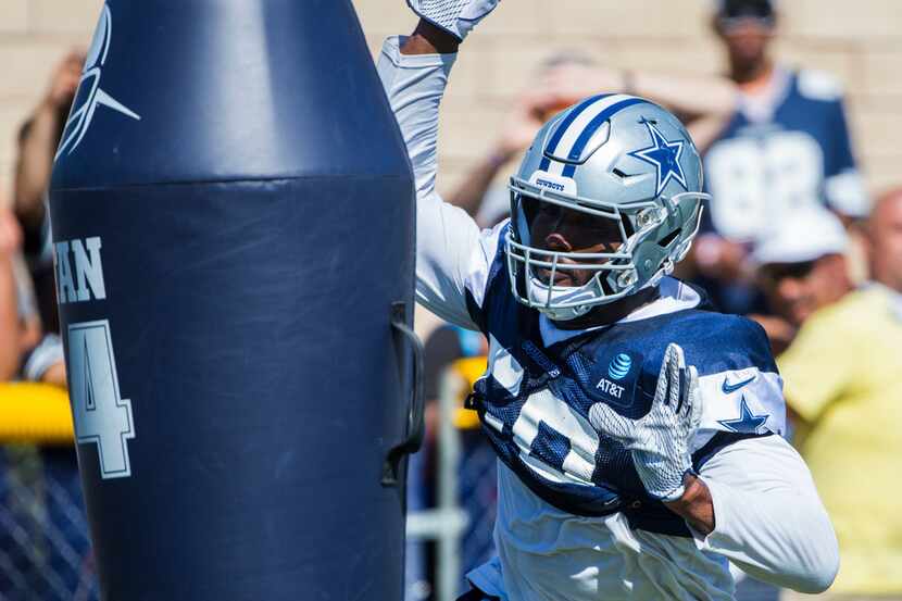 Dallas Cowboys defensive end Robert Quinn (58) attacks a dummy during an afternoon practice...