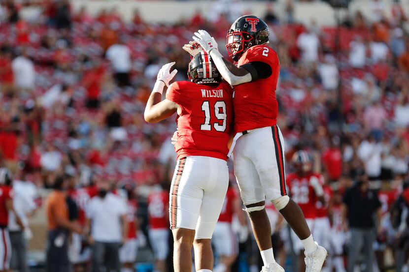 Texas Tech defensive lineman Tyree Wilson celebrates his sack with linebacker Brandon...