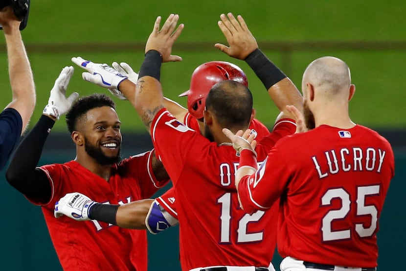 Texas Rangers center fielder Delino DeShields (3) celebrates with players after scoring on a...