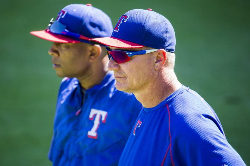 Texas Rangers third base coach Tony Beasley (27) and Texas Rangers manager Jeff Banister...