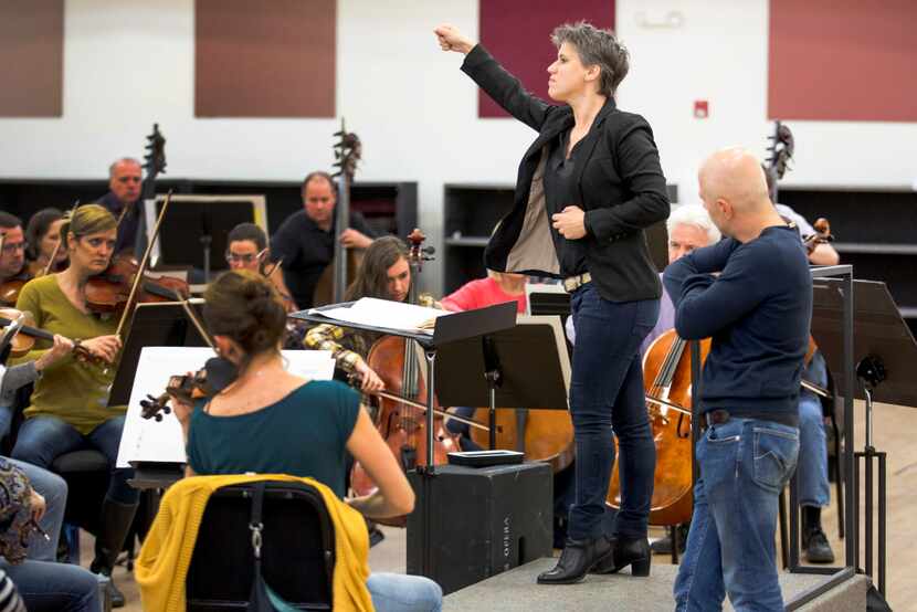 Alexandra Cravero conducts the Dallas Opera Orchestra in rehearsal under the eye of Italian...