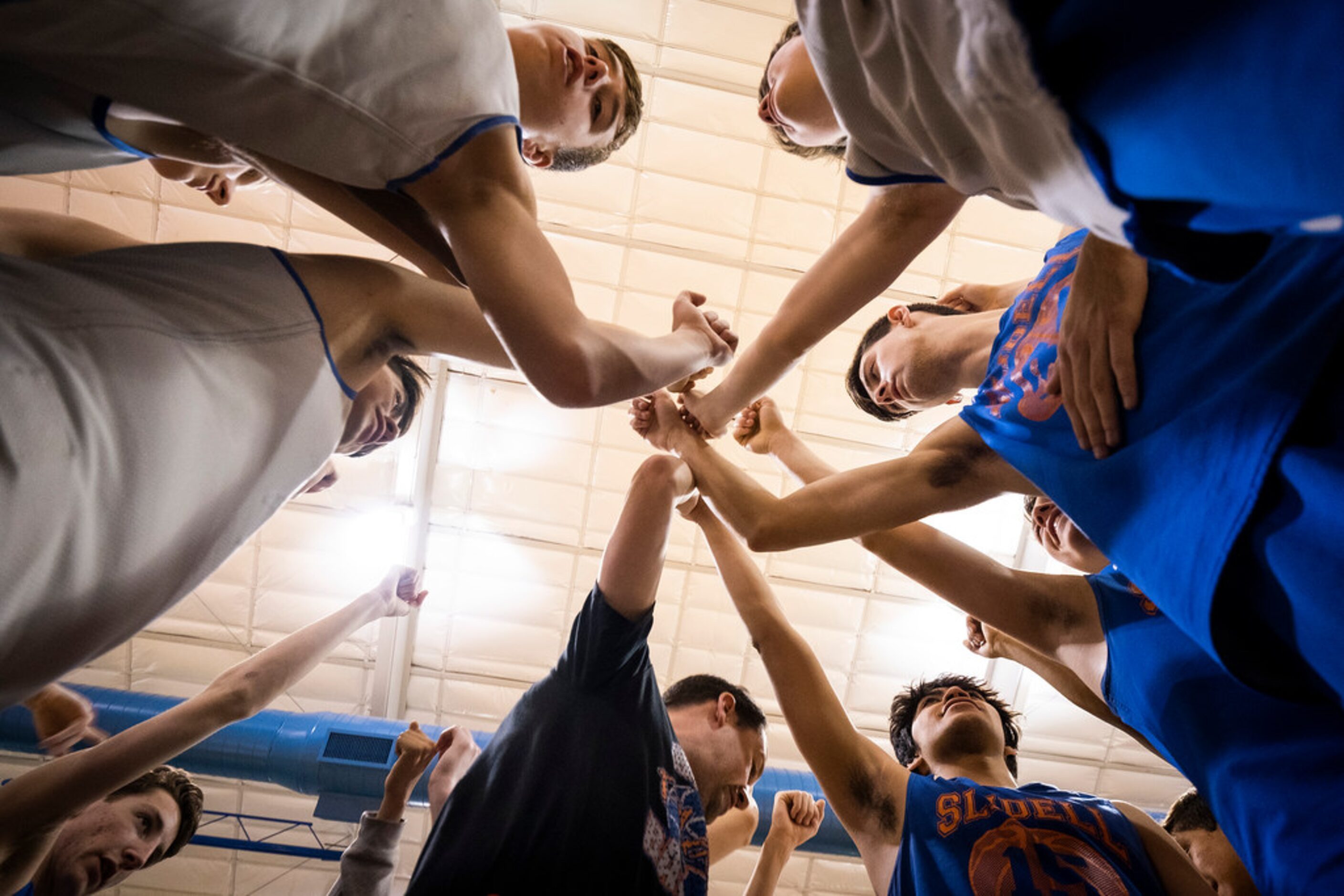 Slidell players huddle around head coach Casey Pierce during practice at the school on...