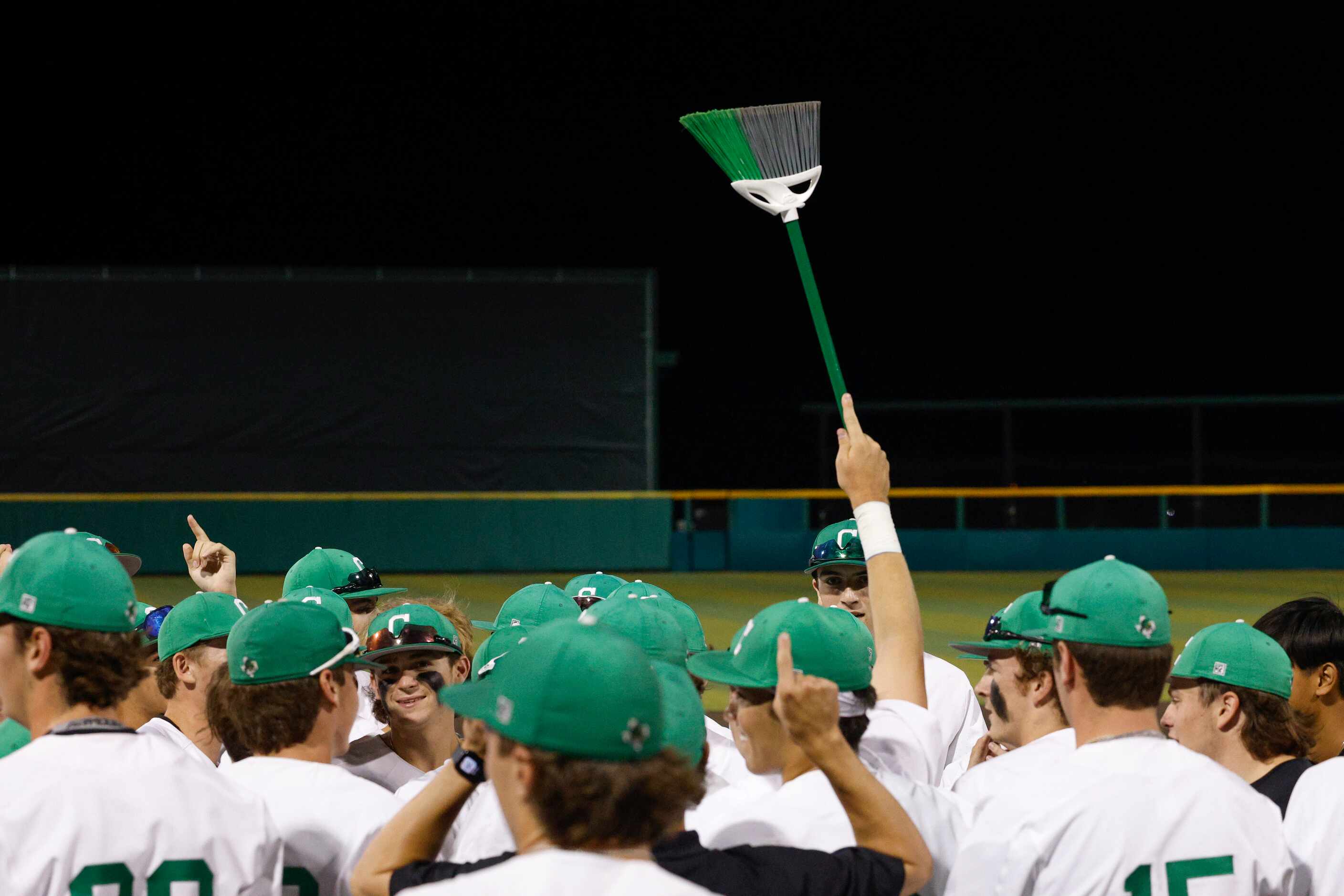 Southlake Carroll players raises a broom after sweeping Keller to win the Class 6A Region I...