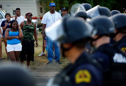  Hundreds of people converged outside Dixon's Grocery after a police shooting in July 2012....