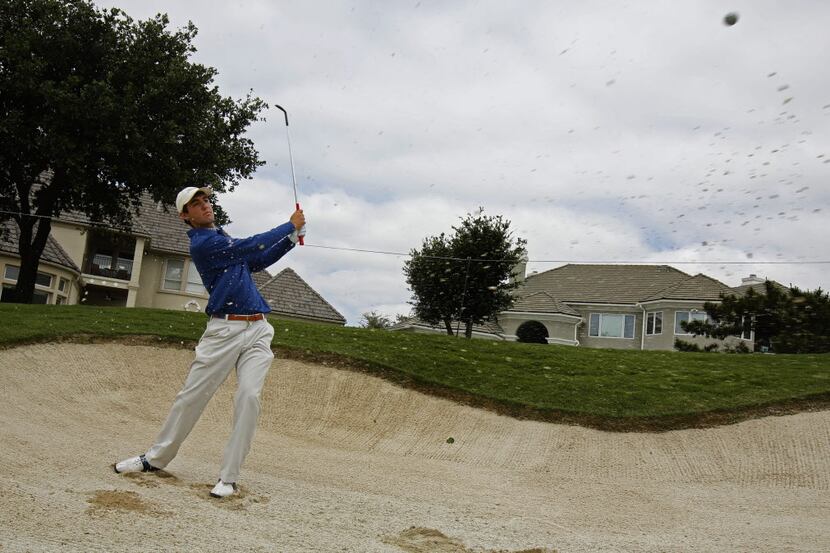 Highland Park golfer Scottie Scheffler hits out of the sand trap during  practice rounds for...