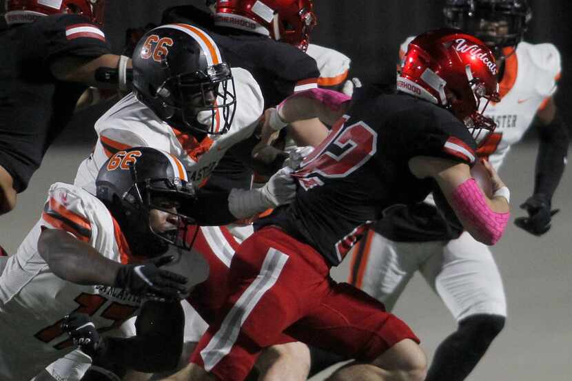 Dallas Woodrow Wilson running back Nathan Barrilleaux (22) is corralled by Lancaster...
