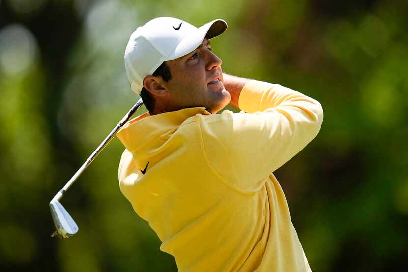 Scottie Scheffler watches his tee shot on the third hole during the first round of the PGA...